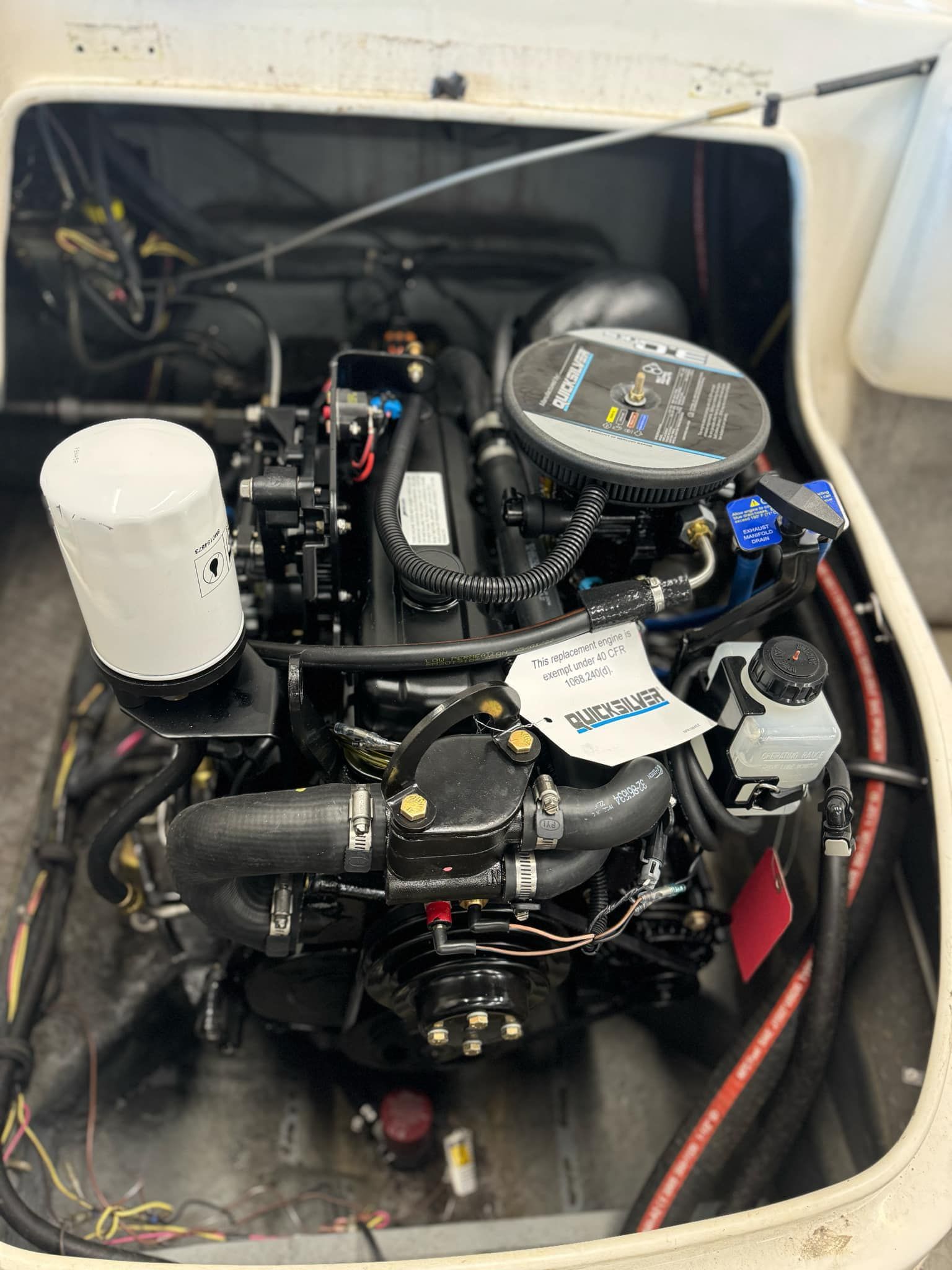 A boat engine is sitting inside of a boat.
