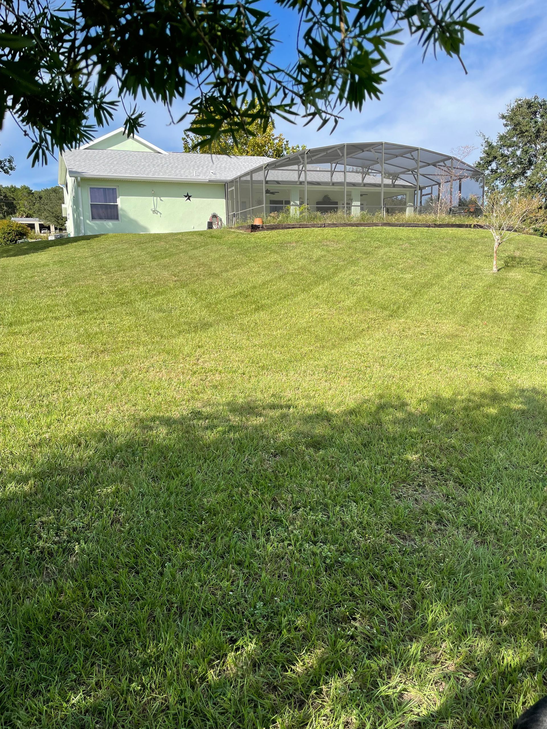 a house with a screened in area in the backyard
