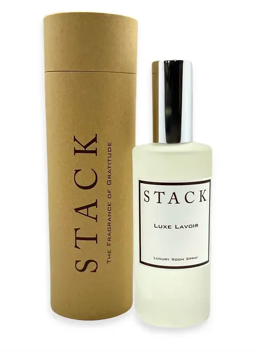 A bottle of stack luxe lavender next to a cardboard tube