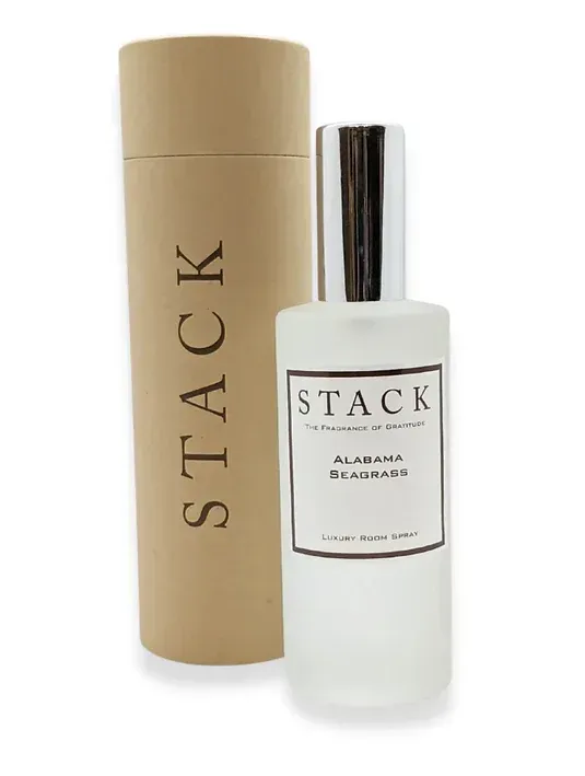 A bottle of stack next to a cardboard tube
