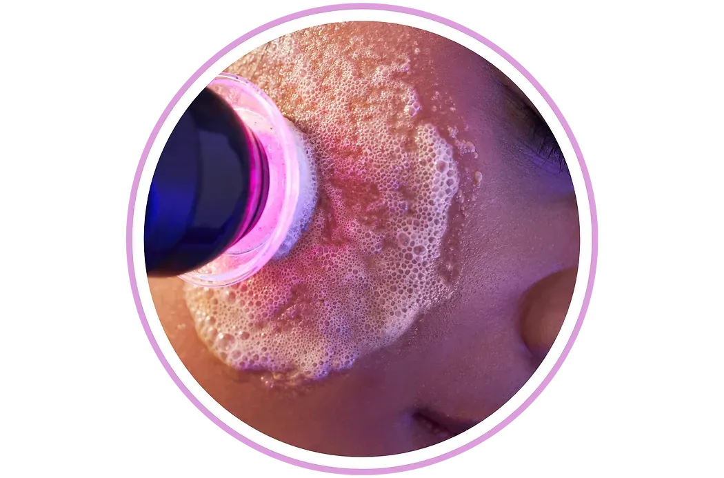 A close up of a person 's face with a purple light shining on it.