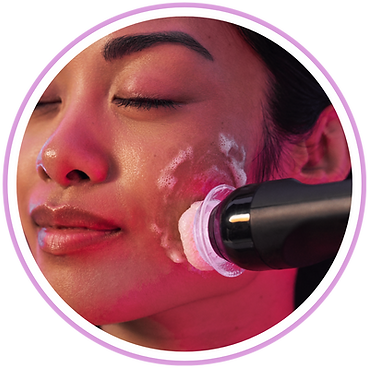A woman is getting a facial treatment with a device on her face.
