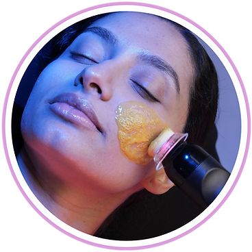 A woman is getting a facial treatment with a brush on her face.
