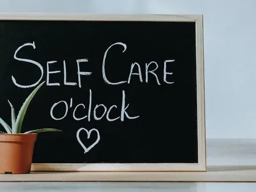 A blackboard with the words self care o clock written on it