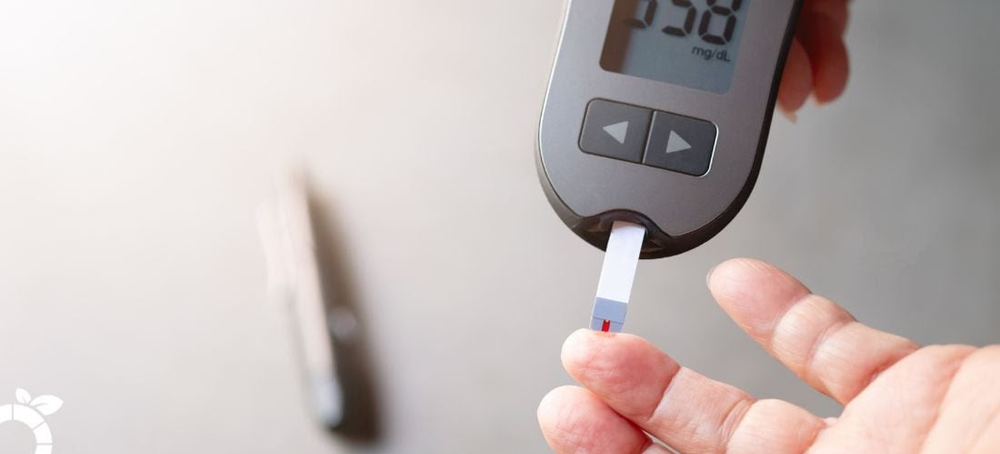 Person testing blood sugar level using a glucose meter.