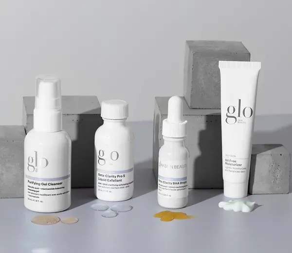 A group of bottles of cosmetics are sitting on a table.