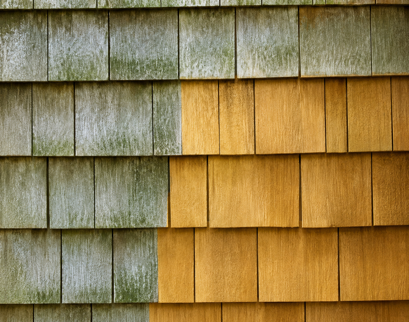 Weathered shingle wall with gray-green left side and golden-brown right side