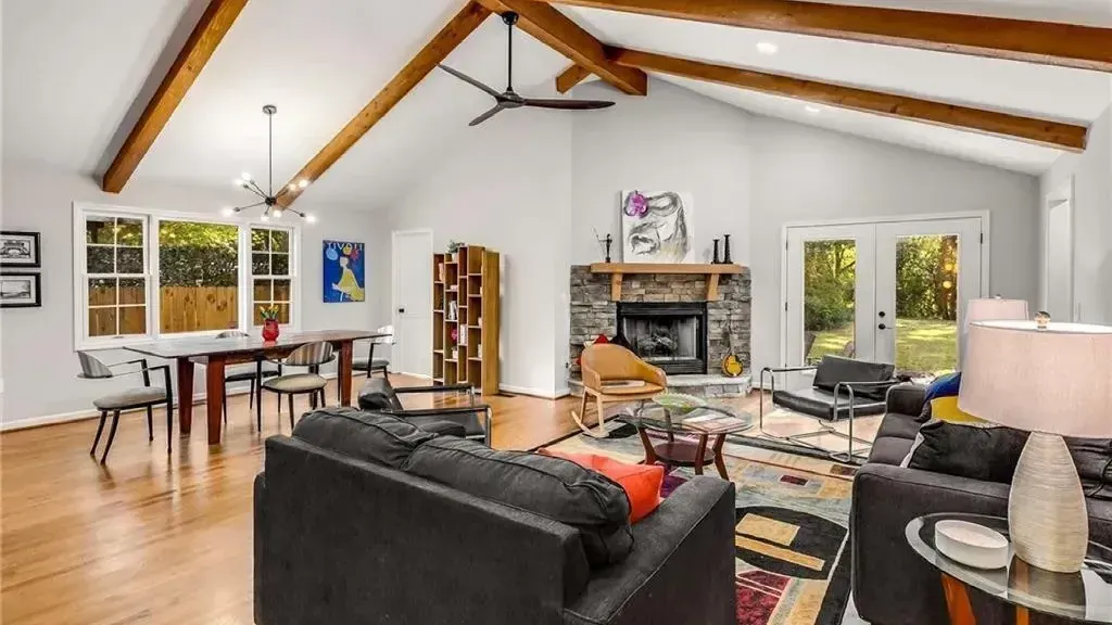 A living room with a ceiling fan and a fireplace