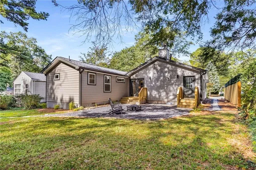 A large house with a large lawn in front of it is for sale.