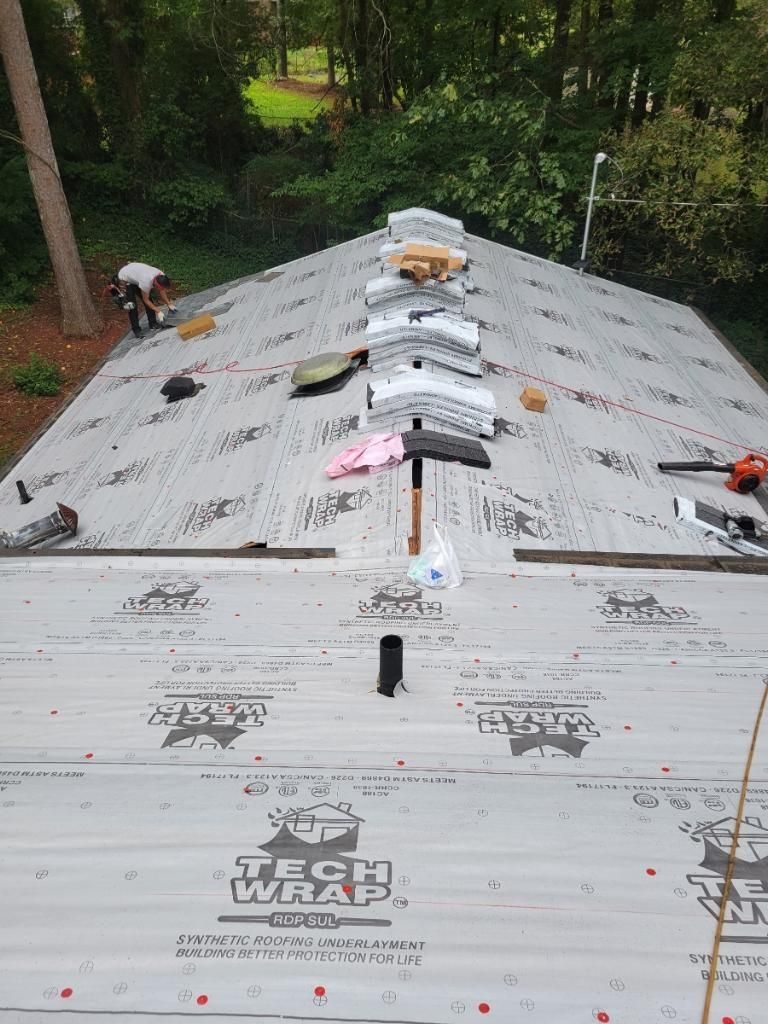 A man is working on the roof of a house.