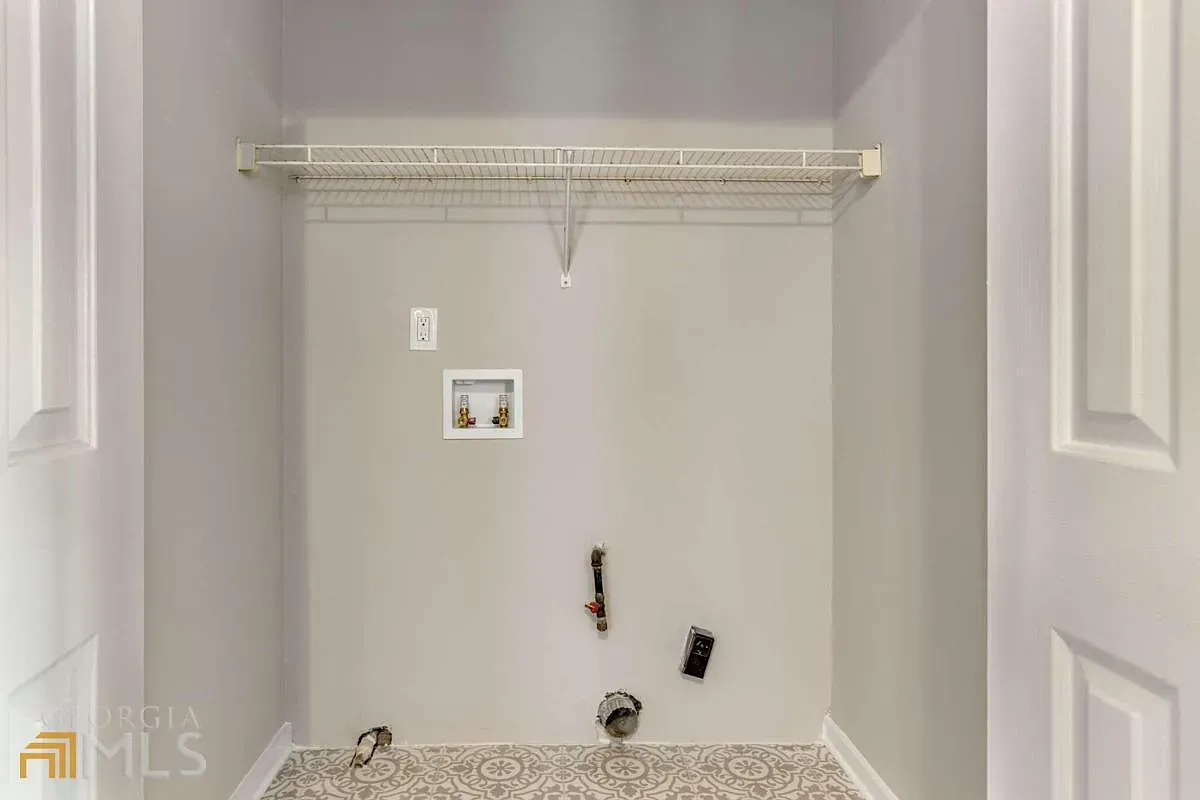 A laundry room in a house with a washer and dryer.