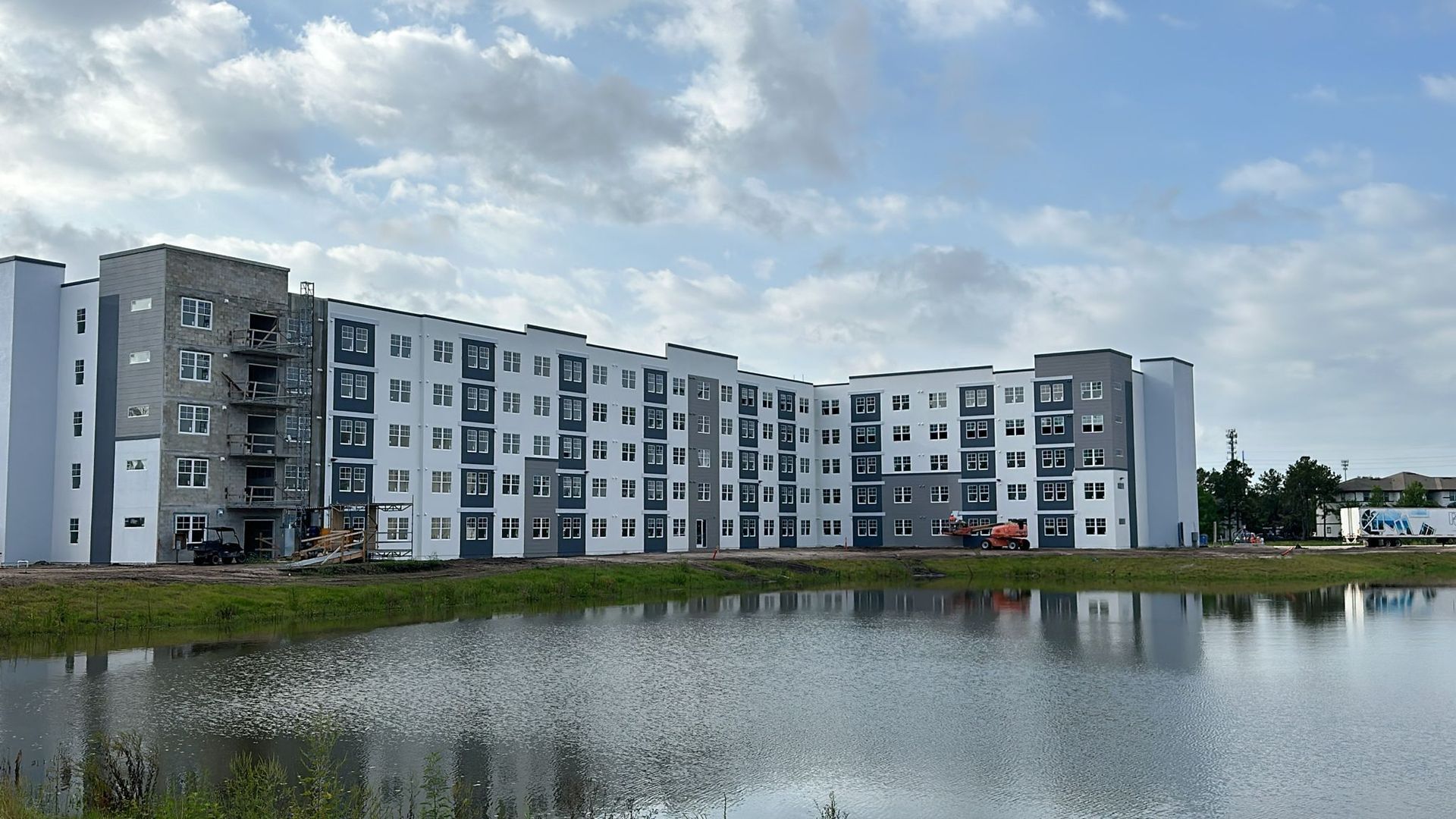 A large building with a lake in front of it