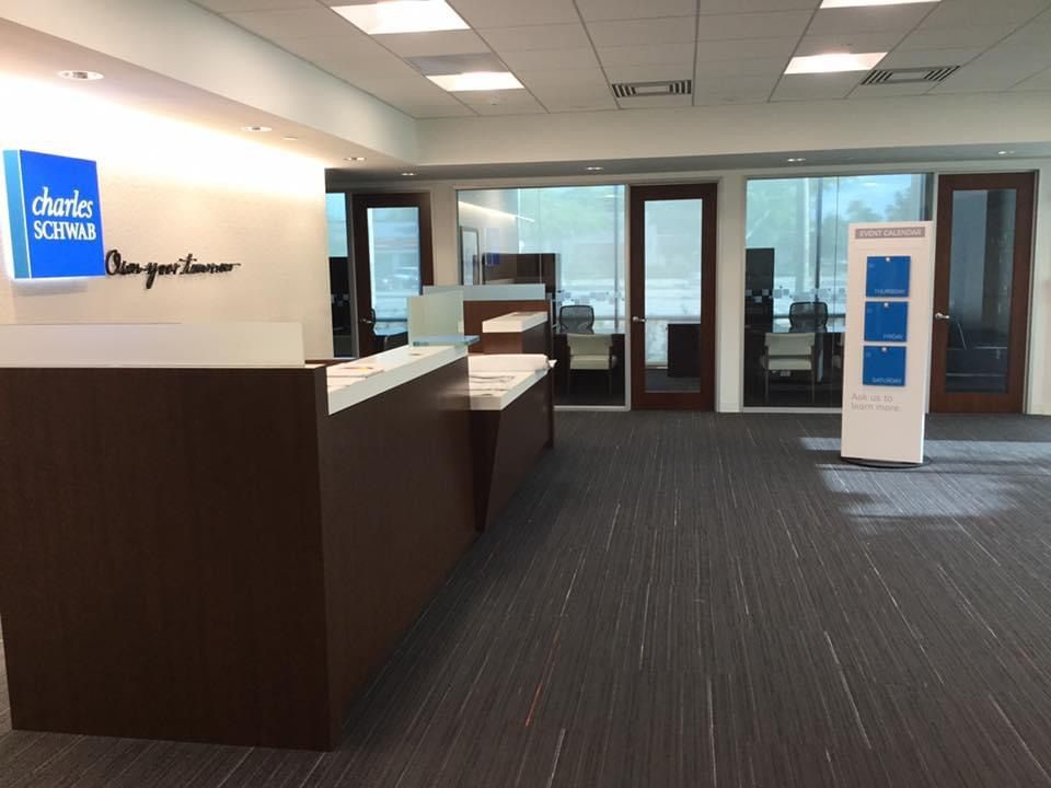 A large room with a charles schwab sign on the wall
