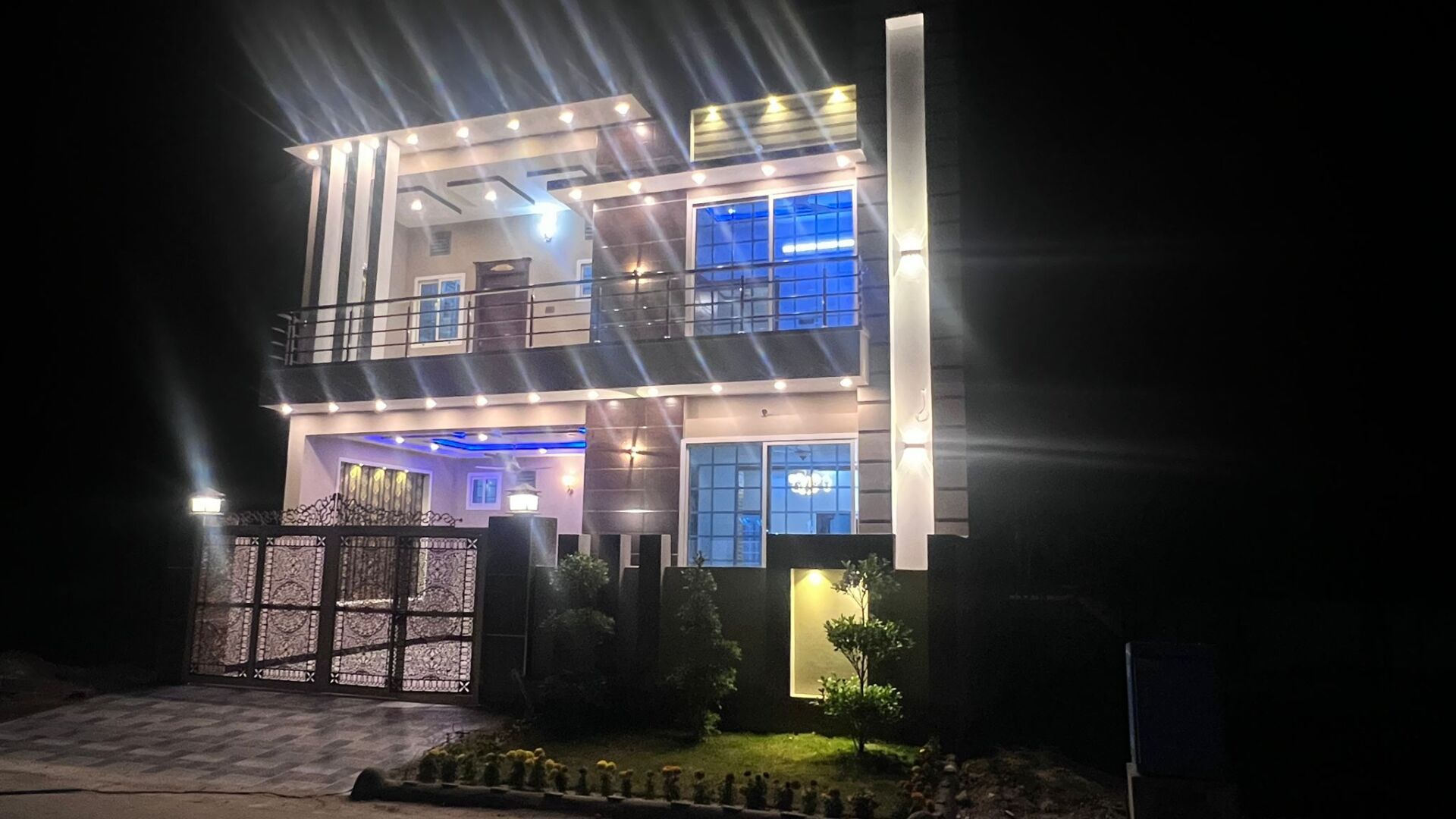 A large house is lit up at night.