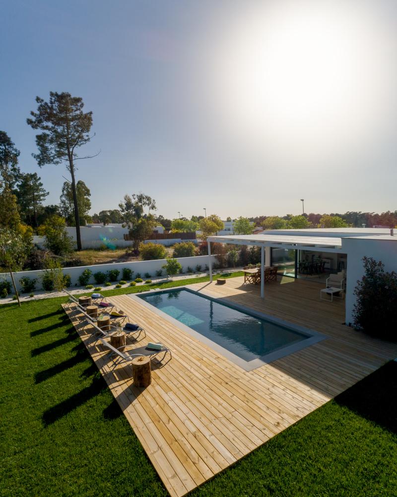 A House With a Large Swimming Pool and a Wooden Deck — B & B Timbers Ballina In West Ballina, NSW