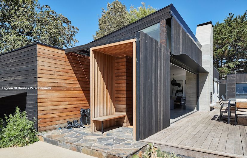 A Modern House With a Wooden Bench in Front of It — B & B Timbers Ballina In West Ballina, NSW