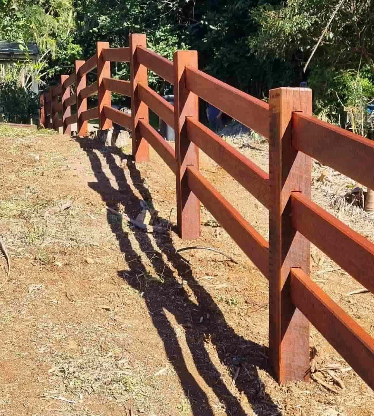 A Wooden Fence With a Shadow on the Ground — B & B Timbers Ballina In West Ballina, NSW
