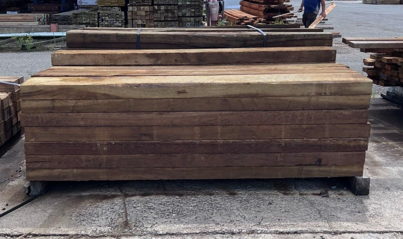 A Stack of Wooden Beams Sitting on Top of Each Other on the Ground — B & B Timbers Ballina In West Ballina, NSW