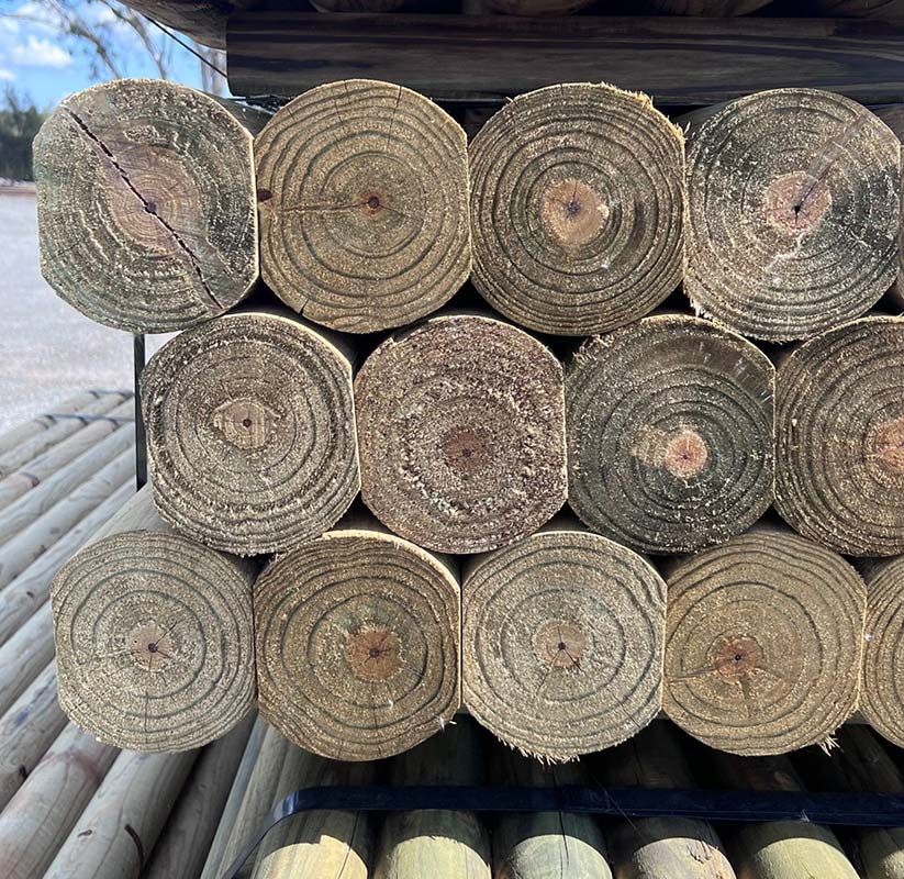 A Bunch of Logs Are Stacked on Top of Each Other — B & B Timbers Ballina In West Ballina, NSW