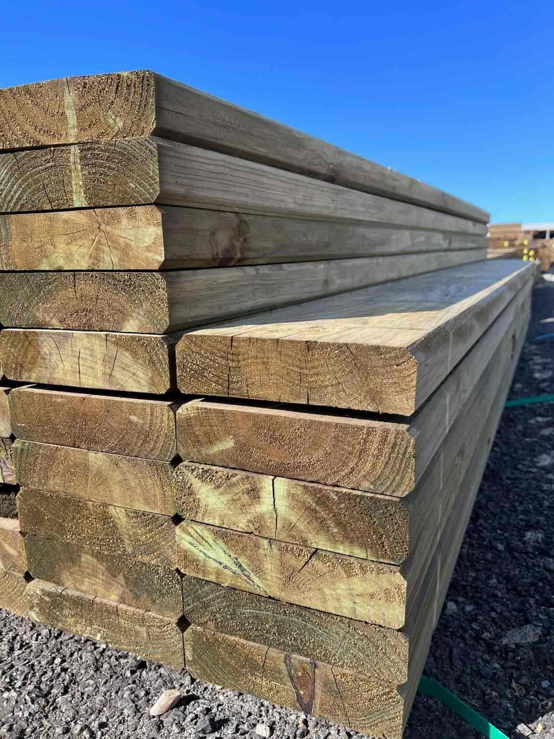 A Stack of Wooden Boards Sitting on Top of Each Other on a Gravel Road — B & B Timbers Ballina In West Ballina, NSW