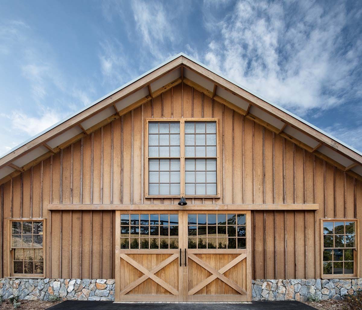 A Large Wooden Barn With Lots of Windows and Doors — B & B Timbers Ballina In West Ballina, NSW
