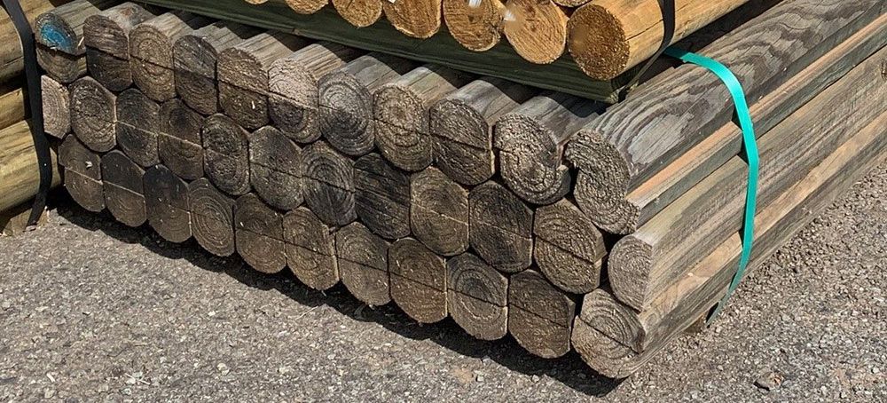A Pile Of Wooden Poles Stacked On Top Of Each Other On The Ground — B & B Timbers Ballina In West Ballina, NSW