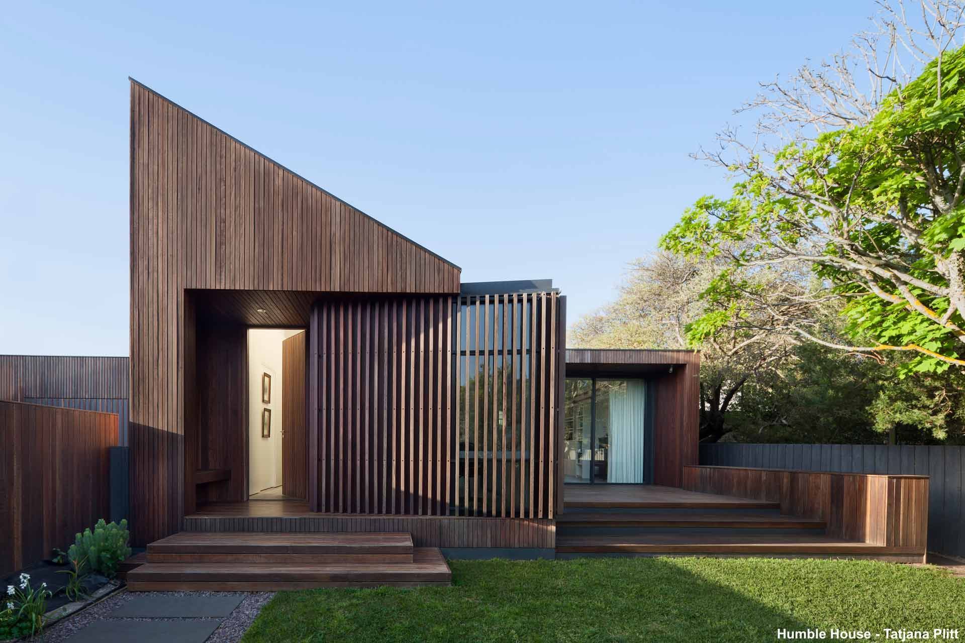 A Small House With a Wooden Facade and a Fence in Front of It — B & B Timbers Ballina In West Ballina, NSW