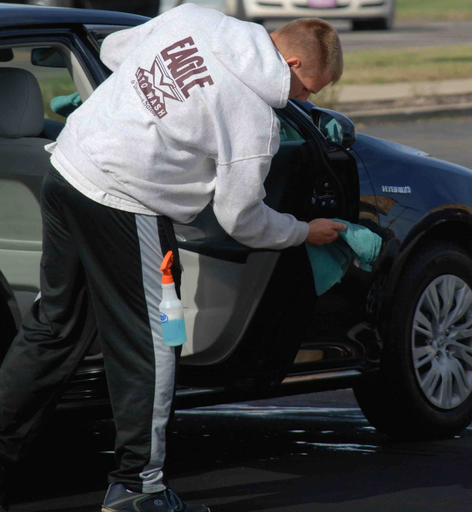 Man Washing A Black Auto — Topeka, Kansas — Eagle Auto Wash & Detailing Salon Man Washing A Black Auto — Topeka, Kansas — Eagle Auto Wash & Detailing Salon