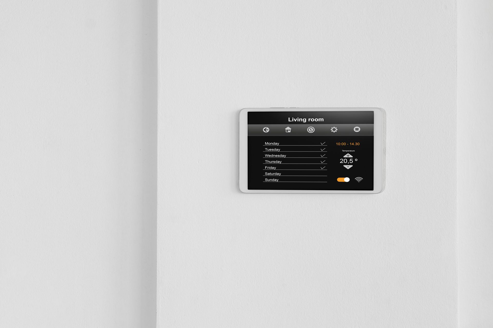 Wall-mounted touchscreen thermostat on a white wall, displaying a dark control menu.
