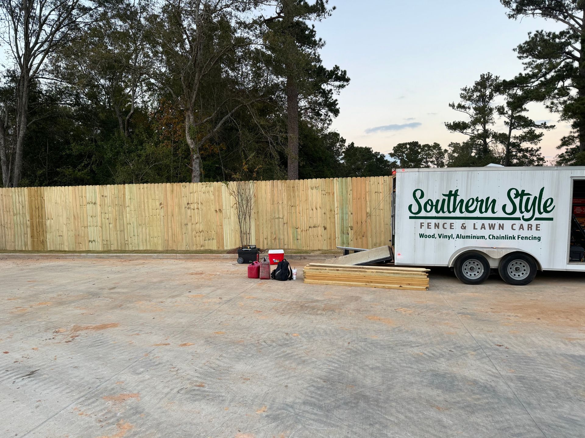 New wooden fence beside a trailer labeled 