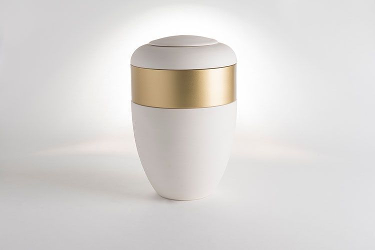 white urn with gold band