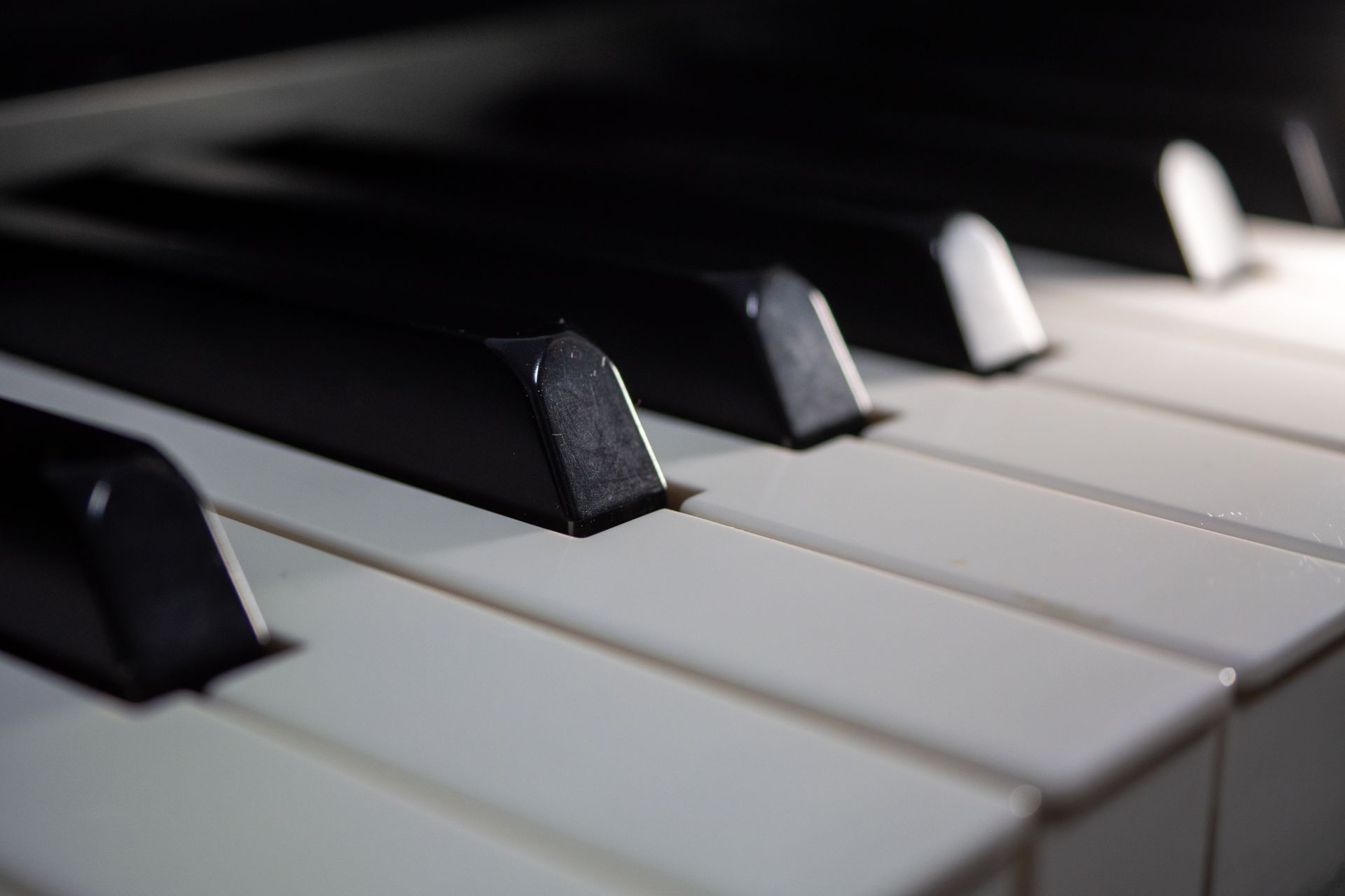 Close-up of piano keys with black and white keys in soft light Close-up of piano keys with black and white keys in soft light