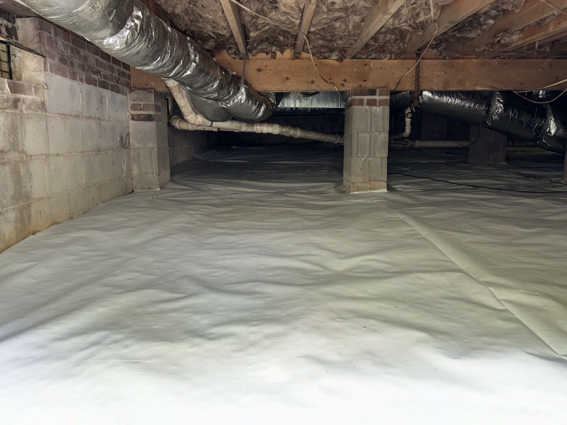 A basement with a lot of pipes coming out of it.