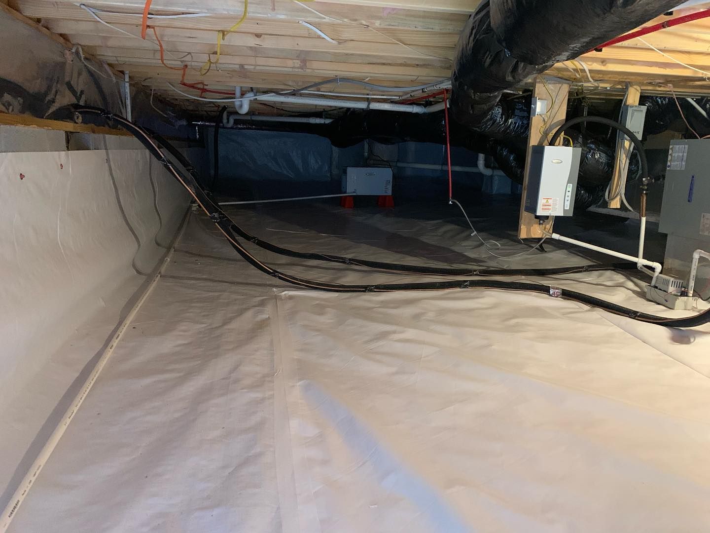 A basement with a lot of wires coming out of it.