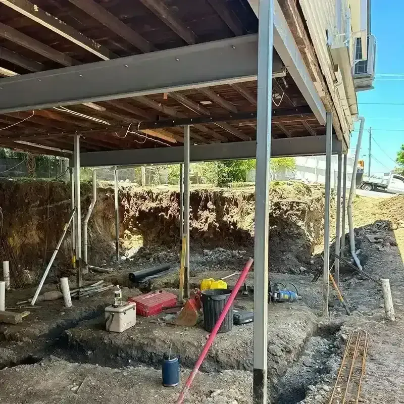 New steel support posts installed beneath a raised timber house during restumping