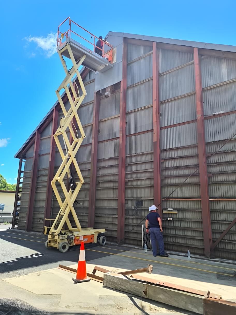 Man is Standing on a Scissor Lift to Do Pest Control — Keiran Mortimer Pest Control in Wilsonton, QLD