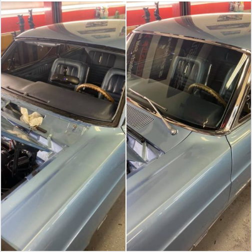 Classic blue car with black vinyl top, shown from front windshield and hood in a garage.