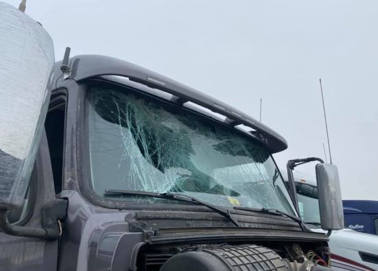 Truck windshield shattered with heavy damage in snowy weather