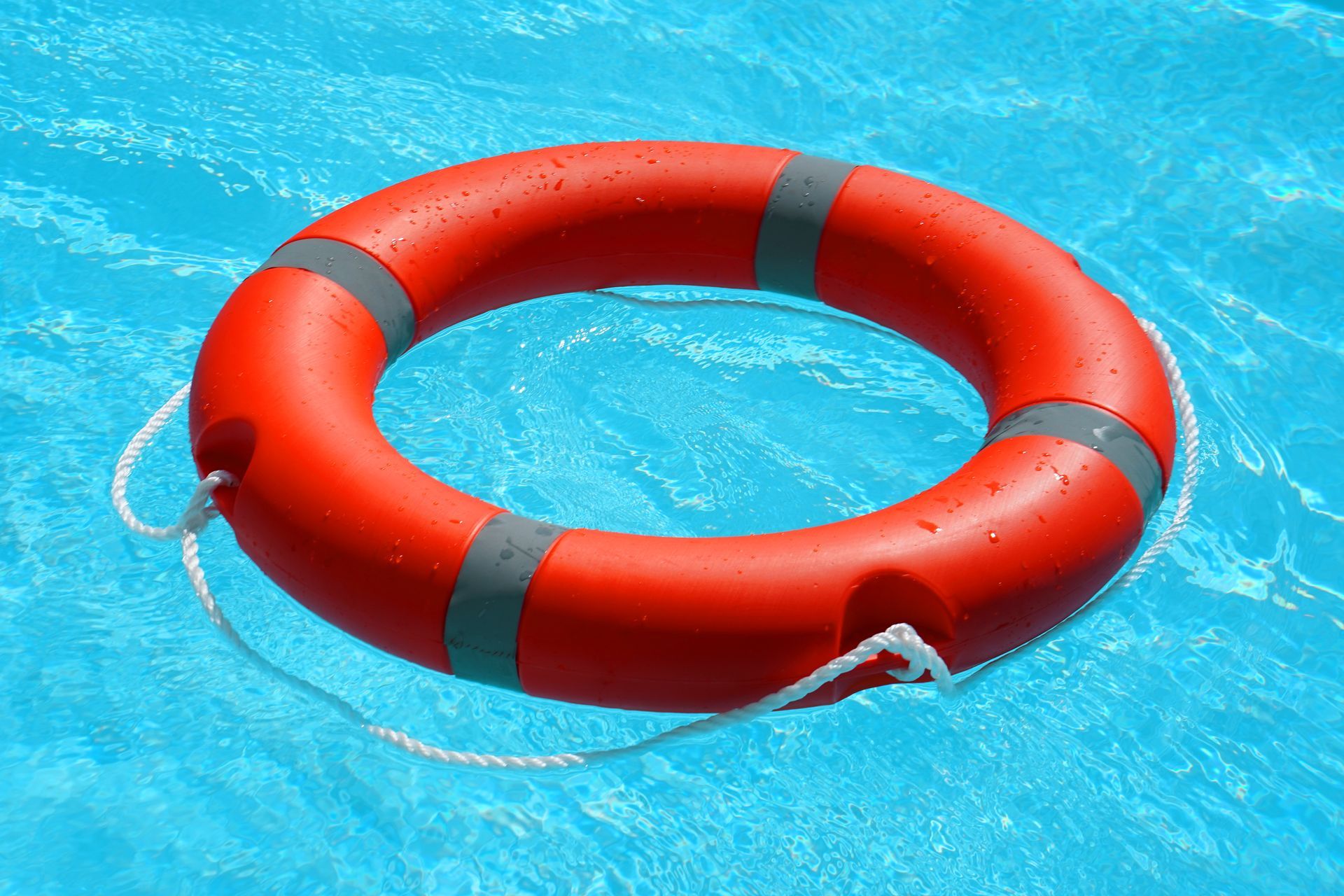 An orange swim ring in the water, representing water safety
