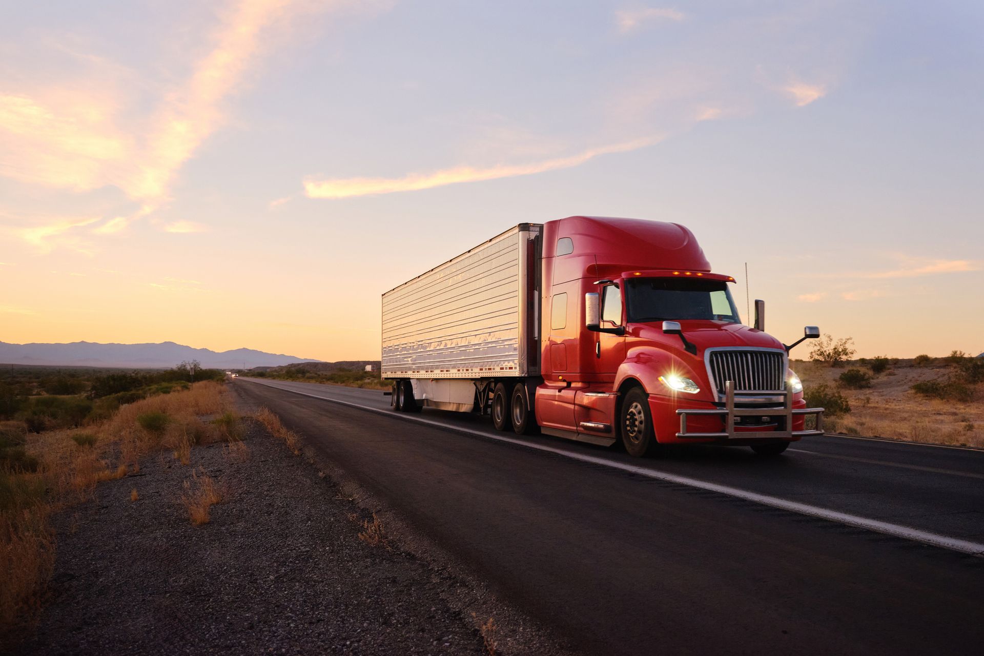 Large semi-truck hauling freight on the open highway. Large semi-truck hauling freight on the open highway.