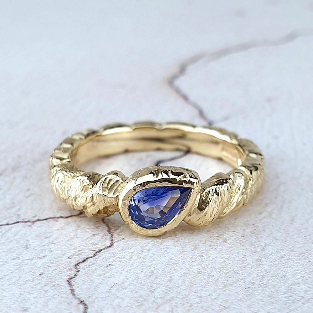 Rugged gold engagement ring with a sapphire Unusual Rugged engagement ring with a sapphire