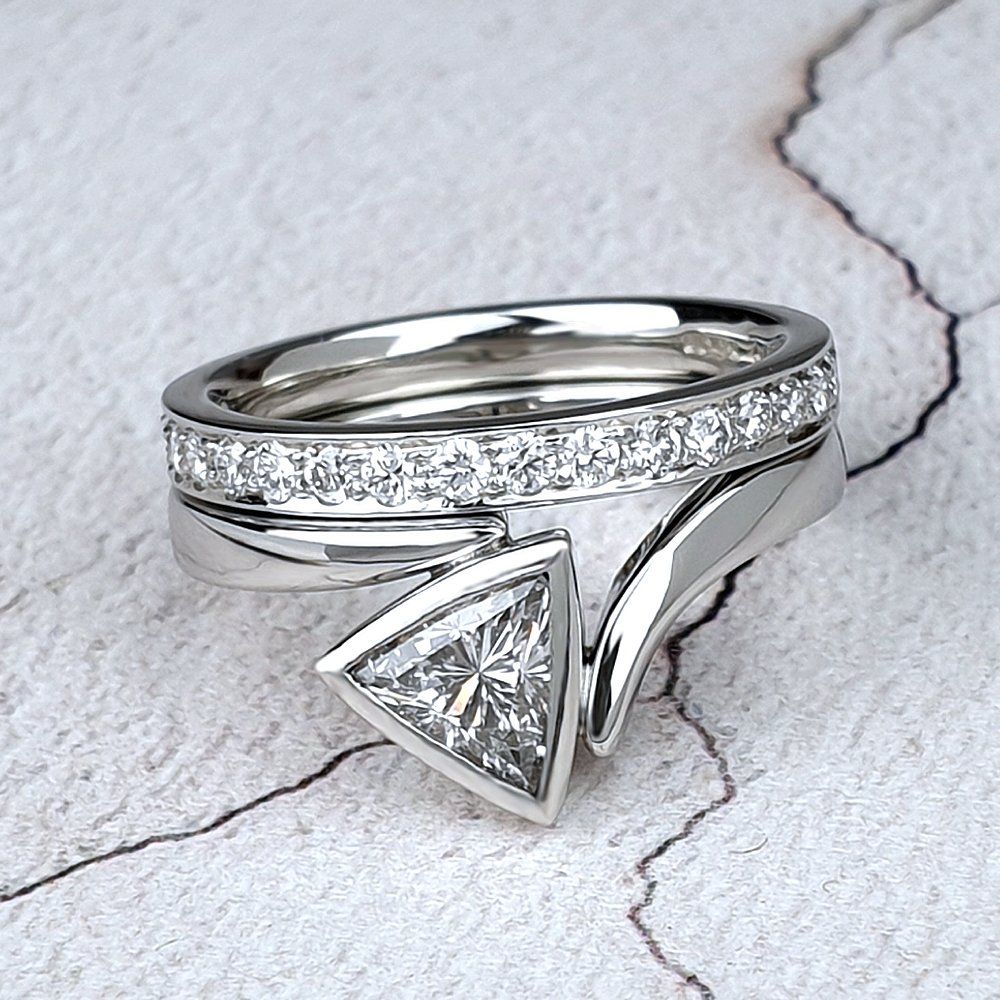 Flick ring shown with a diamond-set wedding band Engagement ring and wedding ring