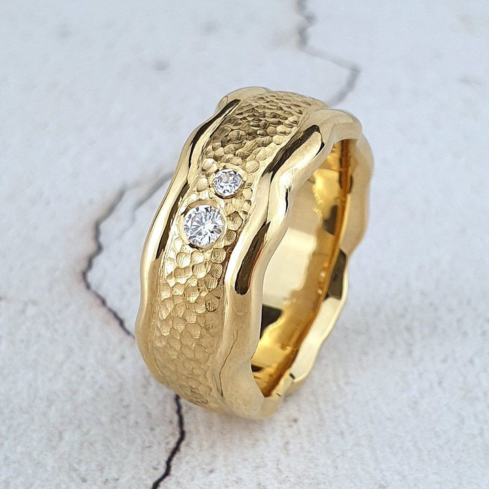 carved gold wedding ring with textured centre