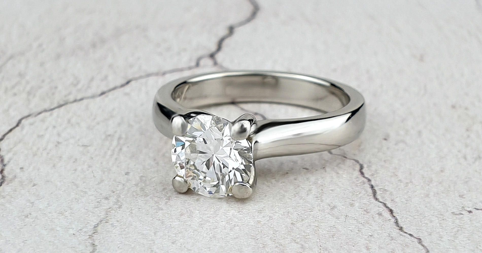 A bespoke platinum wedding ring with a single brilliant cut diamond