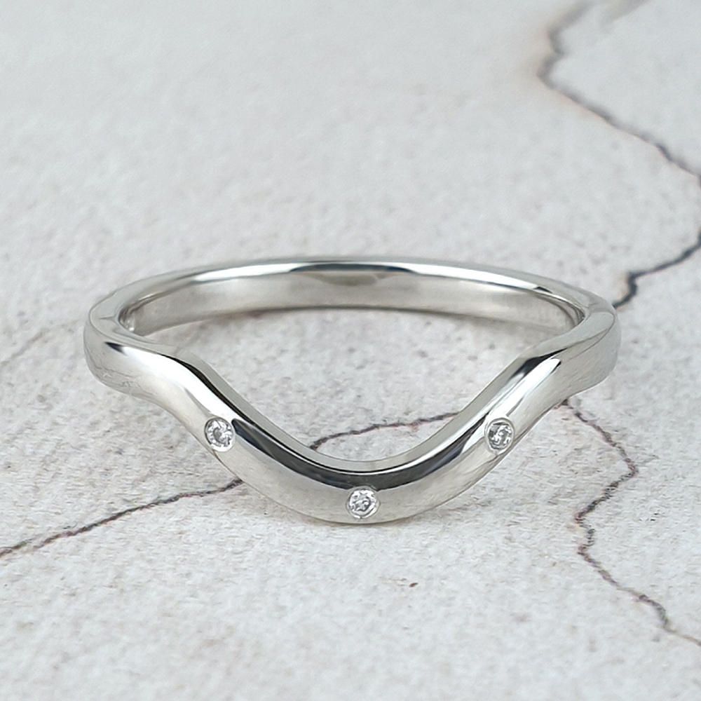 Bespoke curved wedding ring with small diamonds