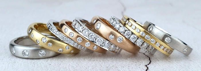A row of bespoke diamond-set wedding rings