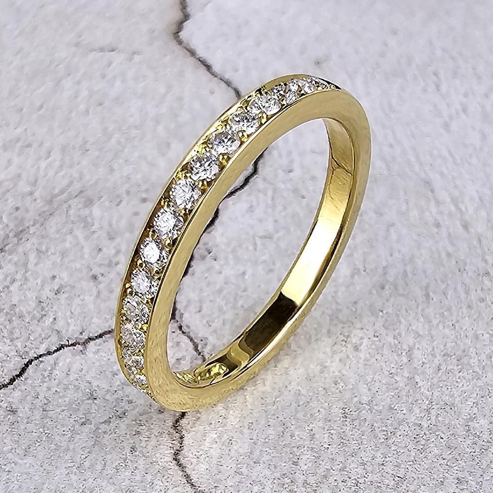 A yellow gold wedding ring with diamonds
