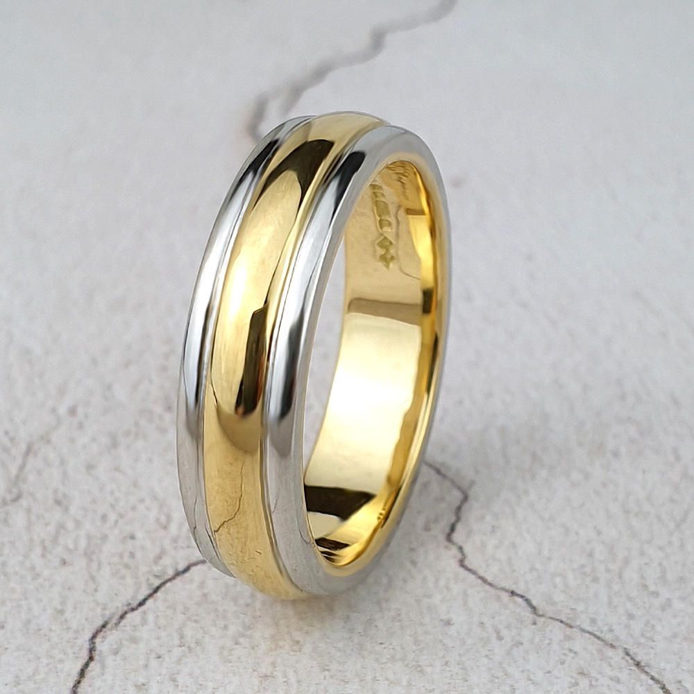 Man's gold wedding ring with platinum edges