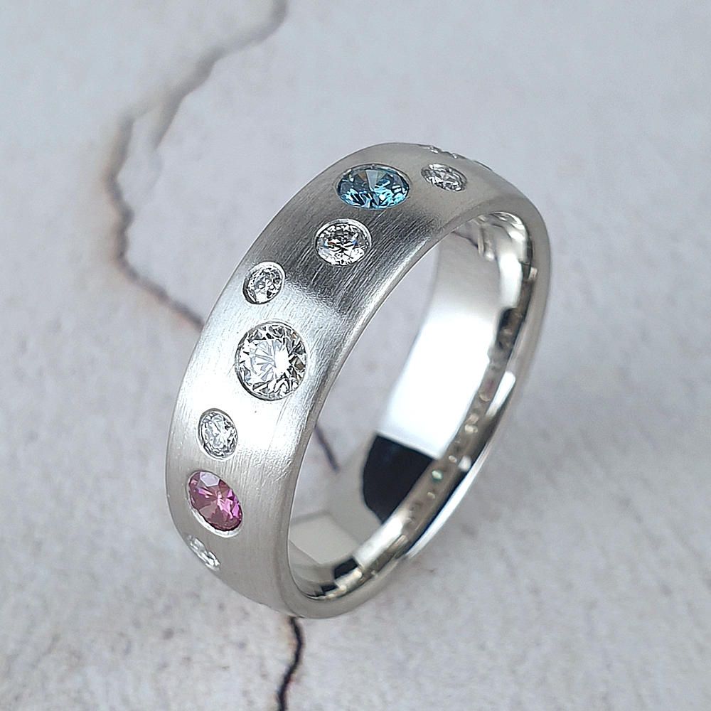 Matte platinum wedding ring with scattered diamonds