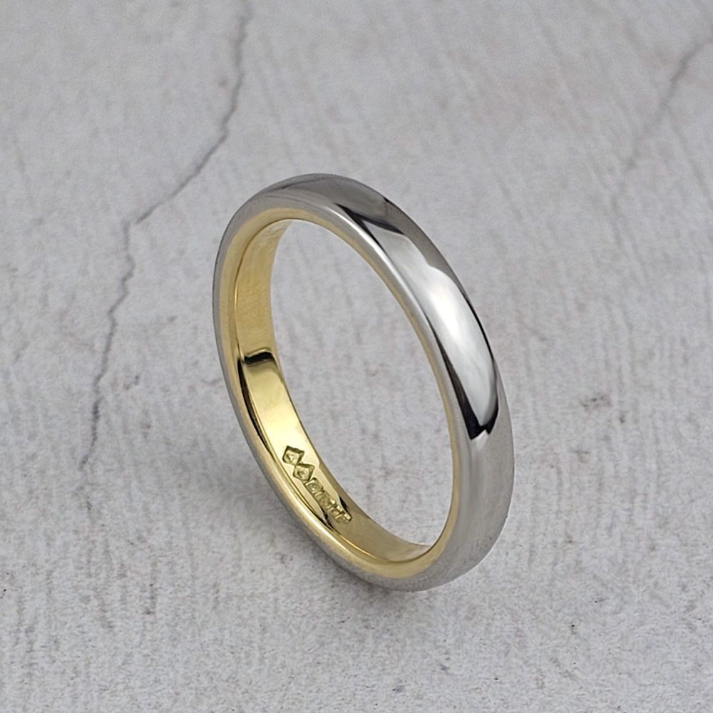 a lady's platinum court wedding ring with a yellow gold lining.